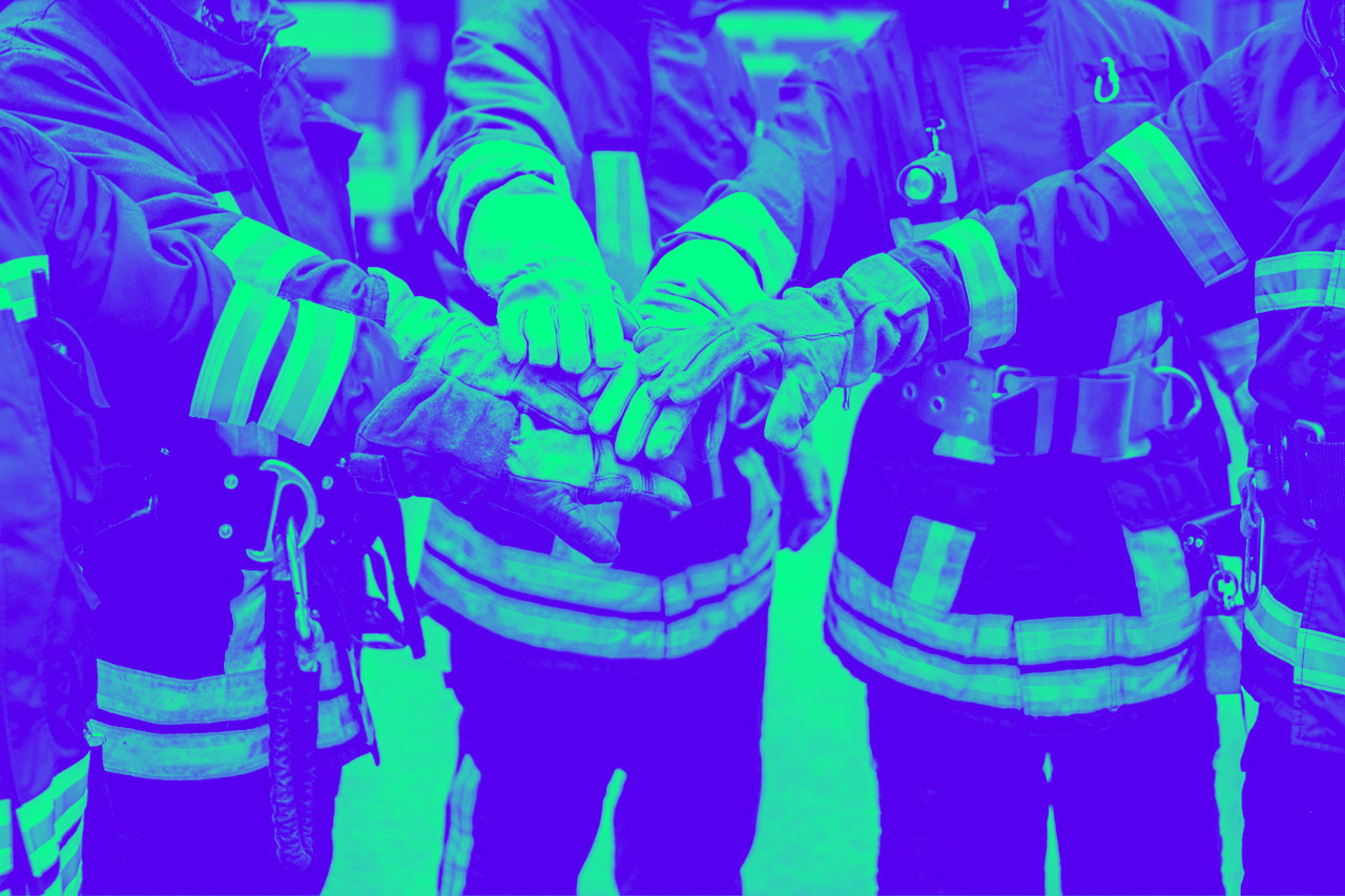 Firefighters with hands stacked