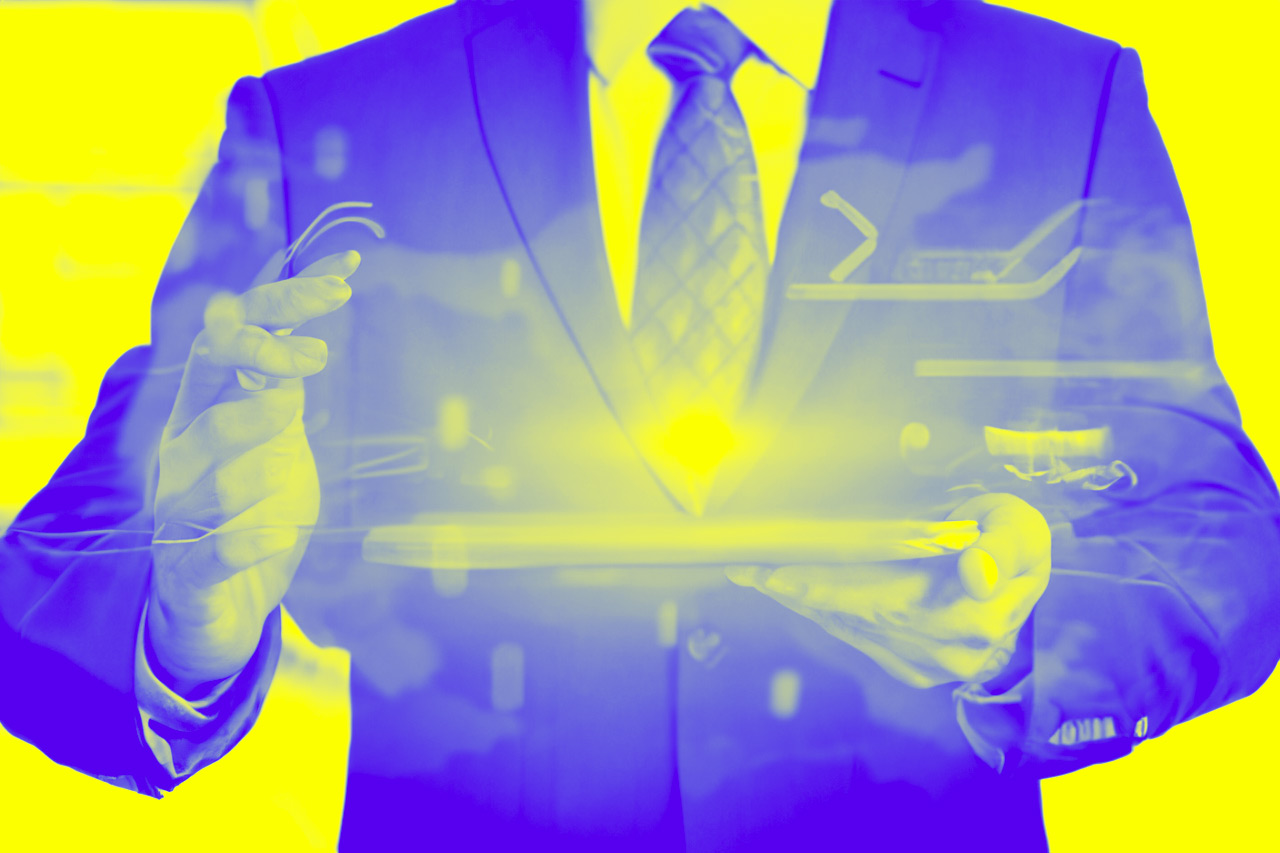 A man in a suit holding a tablet